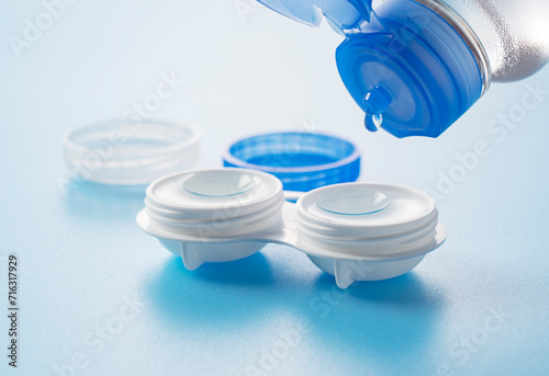 Foto Case of contact lenses placed on a blue background