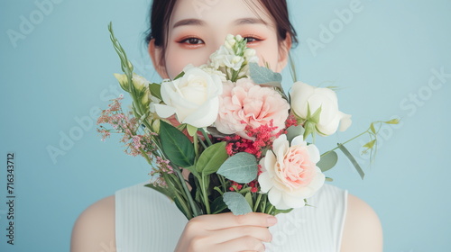 Beautiful asian woman with a bouquet of flowers. studio green background. copy space -Generative AI photo