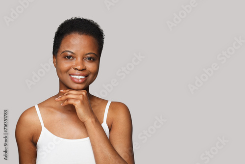 Cheerful smiling woman with healthy fresh clean skin on white background. Facial treatment, skin care and cosmetology concept