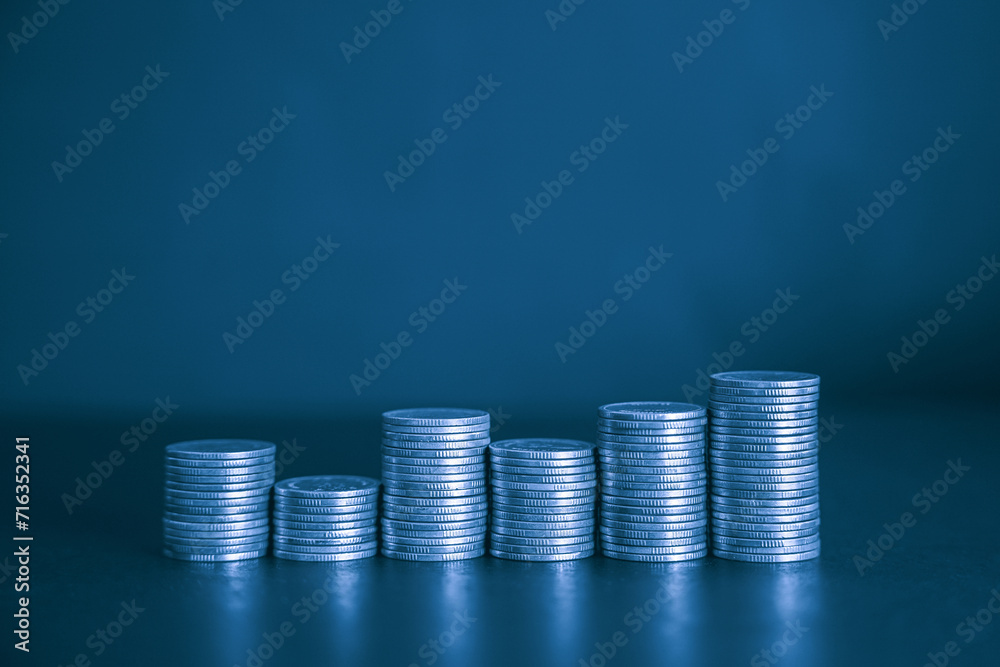 Stack of money Coins Represents Financial Success and Wealth with blue color filter. Business and financial concept. Stack of money Coins Represents Financial Success and Wealth with blue color filter. Business and financial concept.