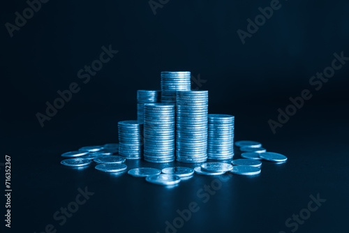 Stack of money Coins Represents Financial Success and Wealth with blue color filter. Business and financial concept.