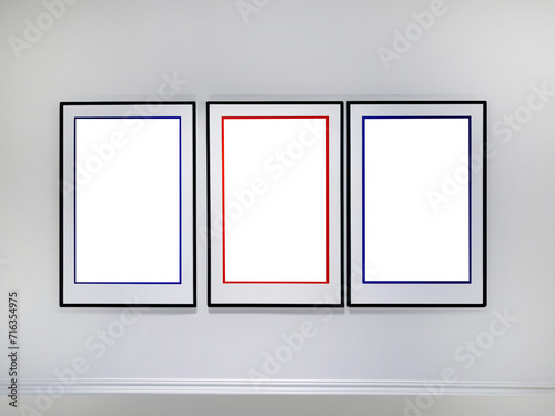 Three transparent cutout vertical picture frames hanging on white wall, Wall art mockup set of 3 posters, blank space frame modern interior style, minimalist © Darr.di