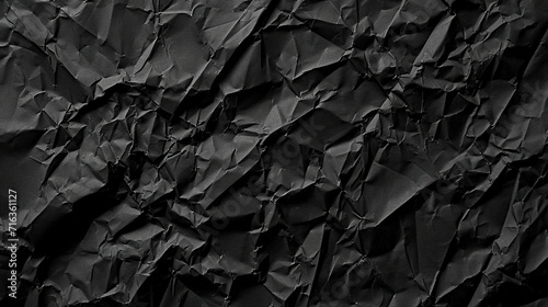 Black crumpled paper background or texture. Crumpled paper. © YULIYA