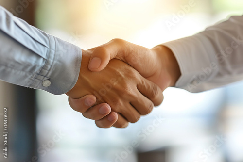 Close-up of hands in a firm handshake after a triumphant partnership in the office, A powerful image capturing the essence of mutual achievement and collaboration, Unity and teamwork concept banner.