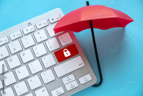 Concept of protection from cyber threat, hacker, computer virus. Red umbrella protect a red button with padlock icon. photo