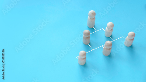 Company hierarchical organizational chart of blocks on blue background with copy space. photo