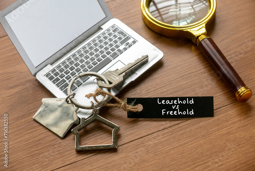 Leasehold vs freehold concept. House key on wooden table.