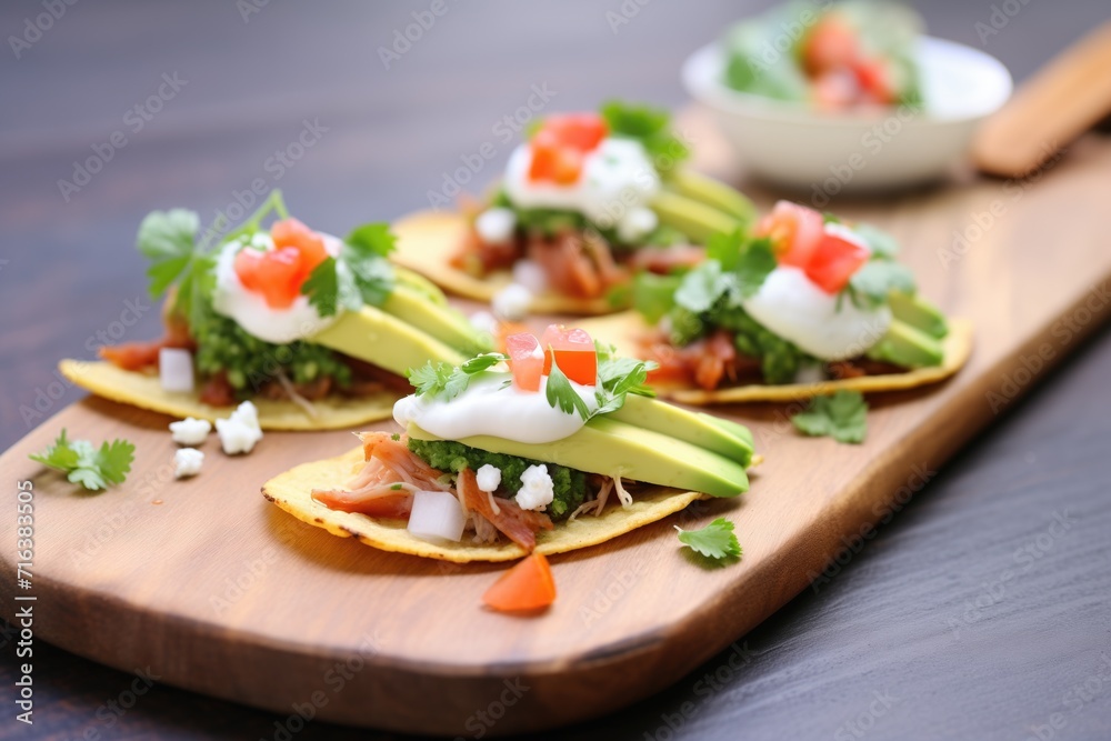 chalupas with avocado slices and sour cream