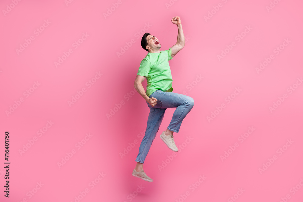 Full length photo of young funny positive overjoyed guy raised fists up shouting his greatness isolated over pink color background