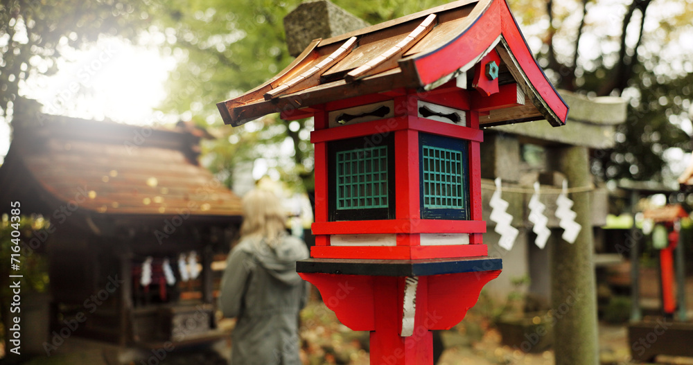 Japan, nature and wooden lantern in Kyoto with trees, tourist and woman with torii gate. Architecture, japanese culture and shinto shrine in woods with sculpture, religion memorial and monument Japan, nature and wooden lantern in Kyoto with trees, tourist and woman with torii gate. Architecture, japanese culture and shinto shrine in woods with sculpture, religion memorial and monument