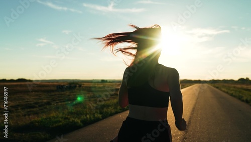 silhouette sports girl running along road sunset  marathon runner sport running. triathlete  running athlete  sports recreation  urban marathon runner crossing finish line  marathon preparation