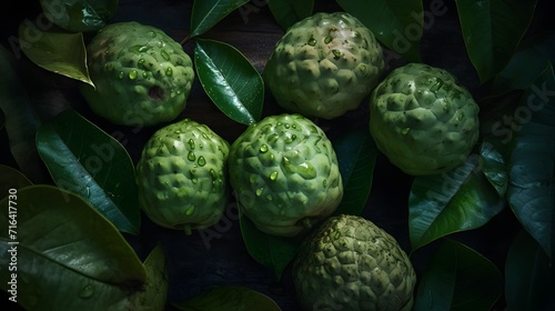 Fresh soursop with water splashes and drops on black background photo