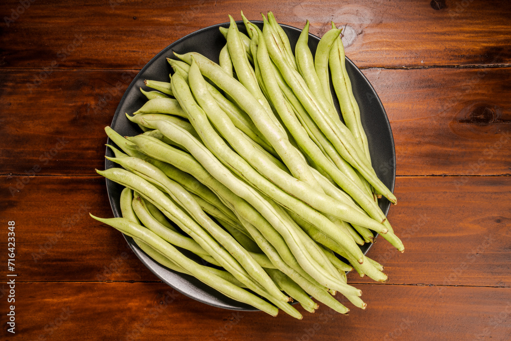 Green bean or Green pea in wooden plate on wooden background. Green bean or Green pea in wooden plate on wooden background.