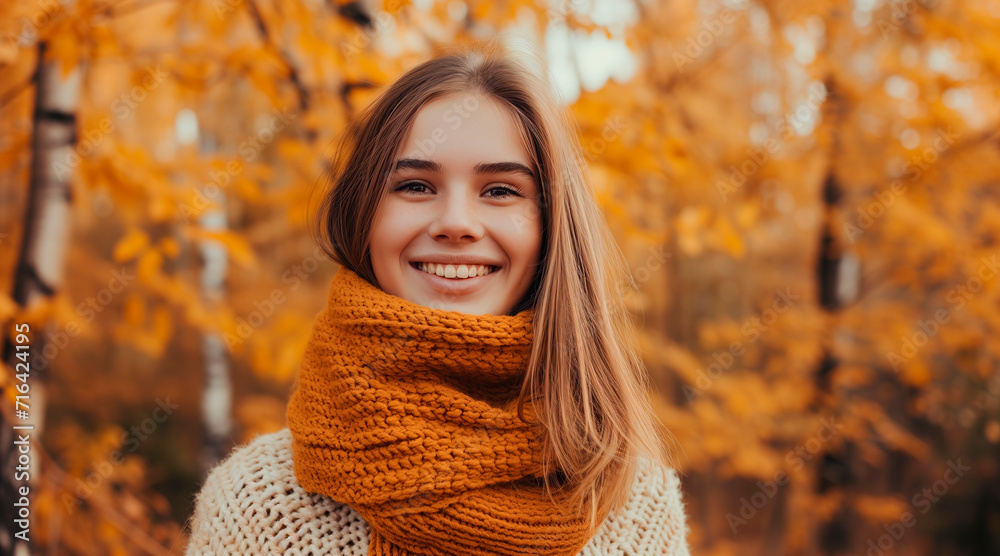 Portrait of young happy smiling girl in autumn park, positive cheerful young woman enjoying a walk outdoors in autumn forest Portrait of young happy smiling girl in autumn park, positive cheerful young woman enjoying a walk outdoors in autumn forest