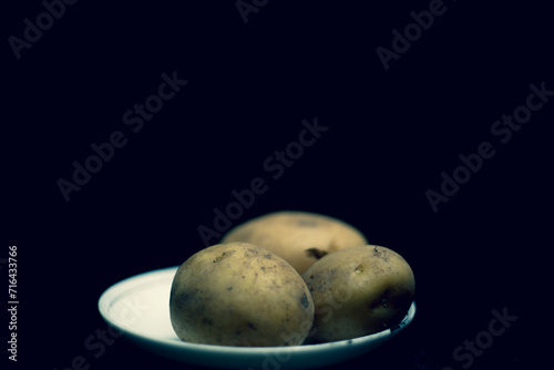 Basket with fresh potatoes,Crop peruvian farmer in bright traditional costume showing heap of freshly picked potato at camera in field in chinchero,High angle view of potatoes and onions in crates at 