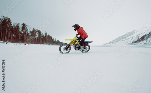 Winter motocross. Racers ride on ice. Winter sports.