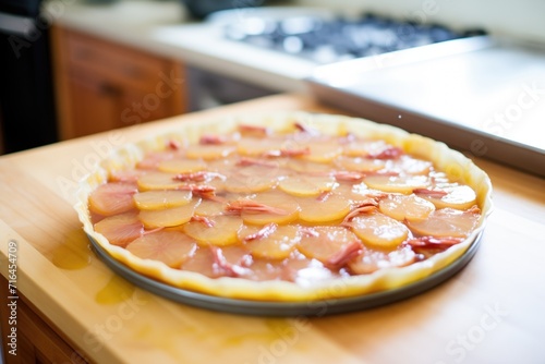 raw tarte tatin before baking with uncooked pastry