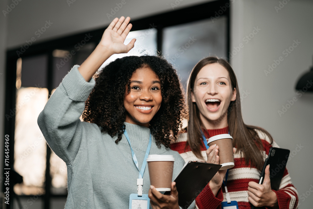 happy smiling business woman waved to greet colleagues at office. happy smiling business woman waved to greet colleagues at office.