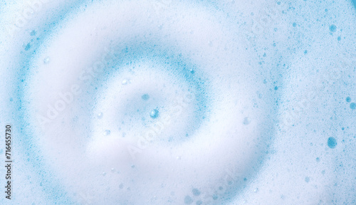 Foam swirl background. Liquid soap bubbles, Froth bubbles backdrop. Soap foam white backdrop. Soap sud macro structure close-up. Clean, cleaning, washing, laundry. Top view