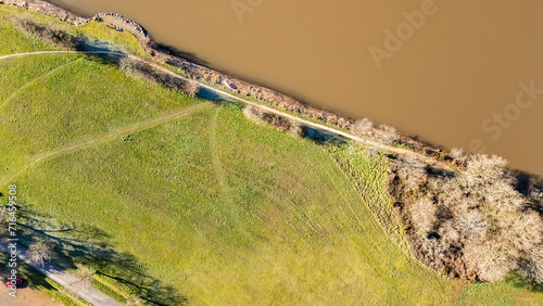 dirt road bordering the Lac du Jaunay in aerial drone view in France photo