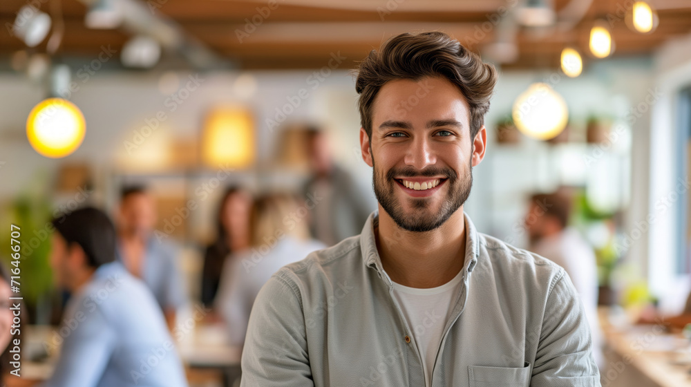 Confident Young Professional in a Busy Office. A cheerful young man with a confident grin in a bustling workplace. Confident Young Professional in a Busy Office. A cheerful young man with a confident grin in a bustling workplace.