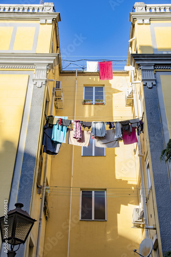 Colorful clothes hanging on some ropes with clothespins