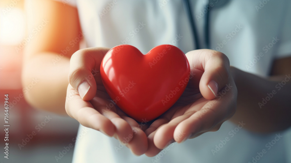 Close up hand of Doctor's hand holding a red heart shape in a hospital. love, donor, world heart day, health, insurance concept.