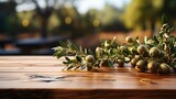 in front of empty brown wood table with blurred olive field background