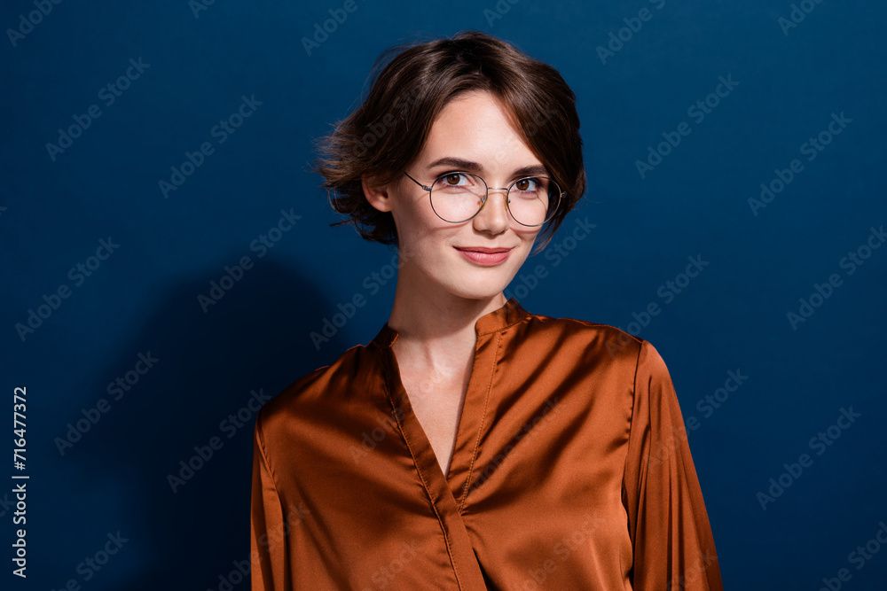 Photo of adorable cute girl wear stylish clothes eyeglasses new collection isolated on dark blue color background Photo of adorable cute girl wear stylish clothes eyeglasses new collection isolated on dark blue color background