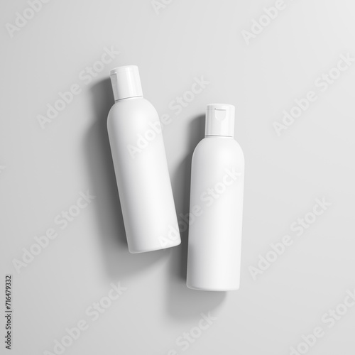 Two flip top bottles lying on the grey background photo