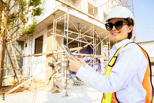 Portrait caucasian female architect oversees construction engineer hold digital tablet check blueprints site planning residential construction projects real estate luxury and environmentally friendly.