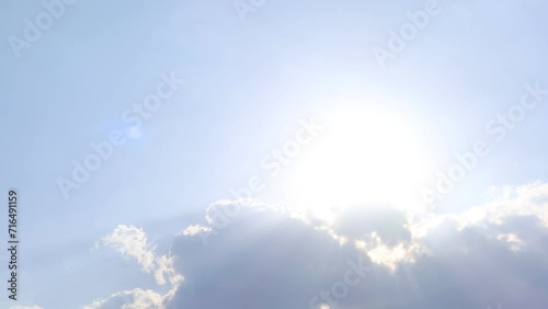 Sun light ray n lens flare or bokeh sunlight shining through dark rain storm cloud or cumulus cloudscap on bright blue sky in tropical summer daylight sunshine day, 4k slow n stop motion TimeLapse