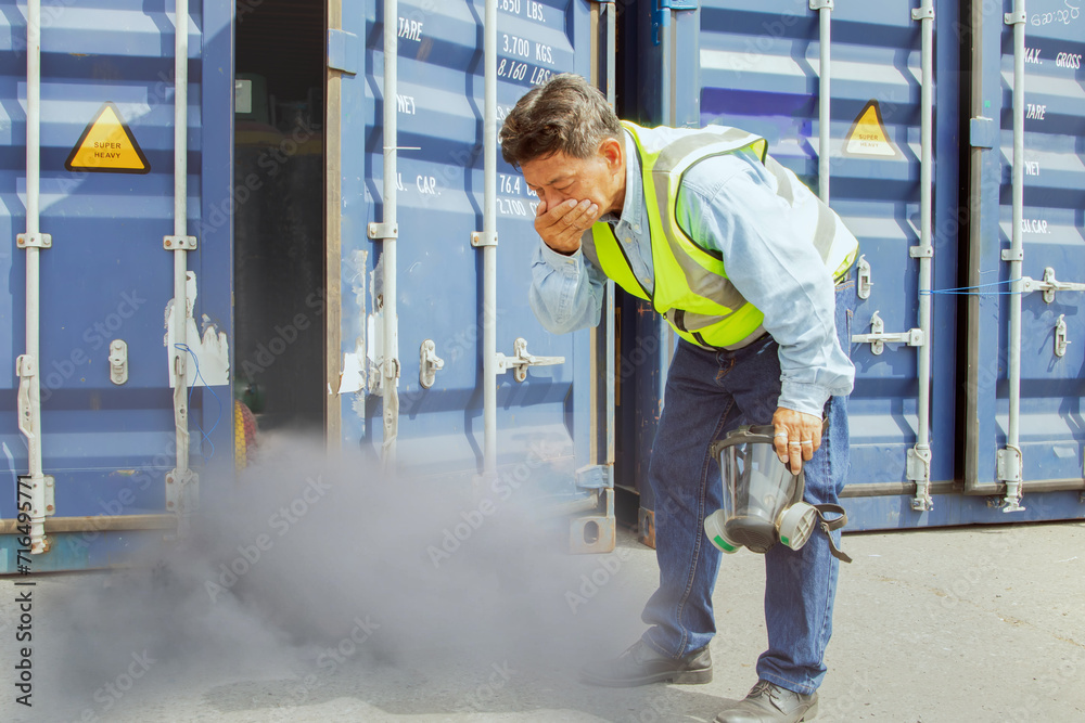 Male worker was about inspect the container holding chemical ammonia protection mask felt stink and felt dizzy because inhaled toxic fumes chemicals that were toxic to the respiratory Male worker was about inspect the container holding chemical ammonia protection mask felt stink and felt dizzy because inhaled toxic fumes chemicals that were toxic to the respiratory