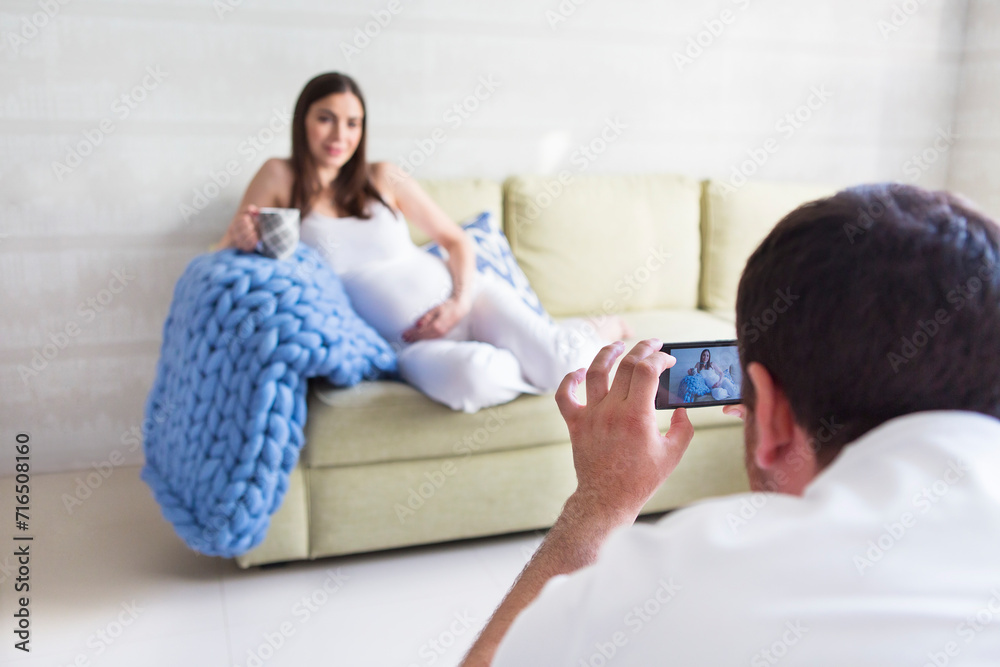 Pregnant woman and young man together indoors Pregnant woman and young man together indoors