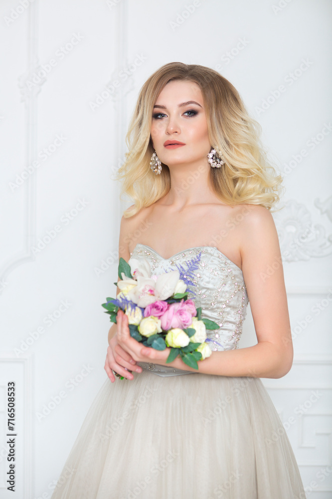Young pretty bride with bridal bouquet indoors Young pretty bride with bridal bouquet indoors