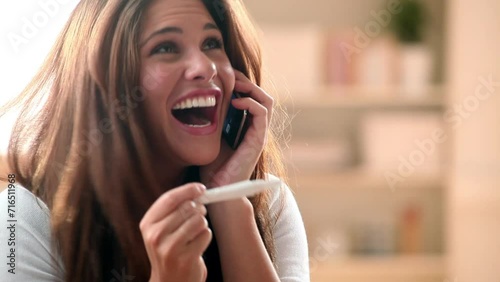 Woman, phone call and pregnancy test for happy good news communication, celebration or ivf. Female person, announcement and excited for healthy results for fertility stick for care, surprise or smile photo