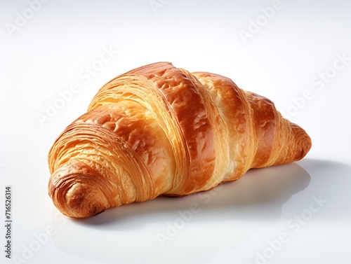 Fresh croissant on white background, close up shot.