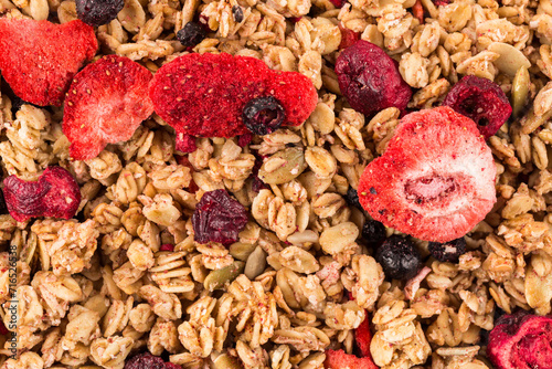 Muesli oat cereals close up background with dry fruits