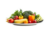 Assorted fresh vegetables artistically arranged on a plate against transparent background, featuring vibrant bell peppers, squash, avocado, and tomatoes, ideal for a healthy diet