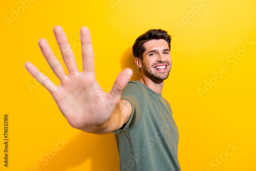 Canvas Print Photo of friendly good mood man with bristle dressed khaki t-shirt giving you hi