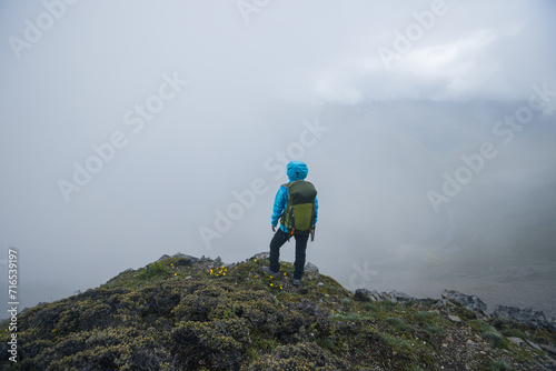 Woman hiker hiking on mountain top