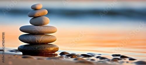 Tranquil zen stones resting on smooth sand beach in serene natural setting