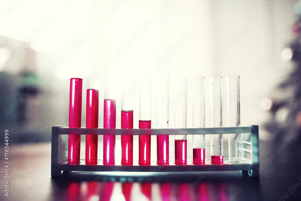 Microscopic examination of blood. Test tubes with red liquid on the laboratory table. Microscopic examination of blood. Test tubes with red liquid on the laboratory table.