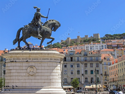 Praca da Figueira Square in the Baixa district in Lisbon , Portugal. King Dom Joao I statue with the Sao Jorge Castle on top of hill photo