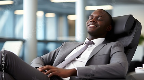 Young employee taking a relaxed break in the office , Young employee, relaxed break, office photo