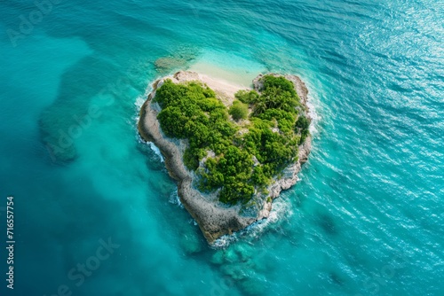 Heart shaped island surrounded by perfect turquoise water in sunlight © Darya Lavinskaya