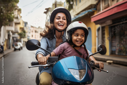A happy smiling mother and child travelling in a scooter through the streets