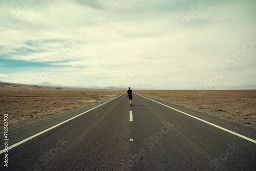A man walking forward on the road