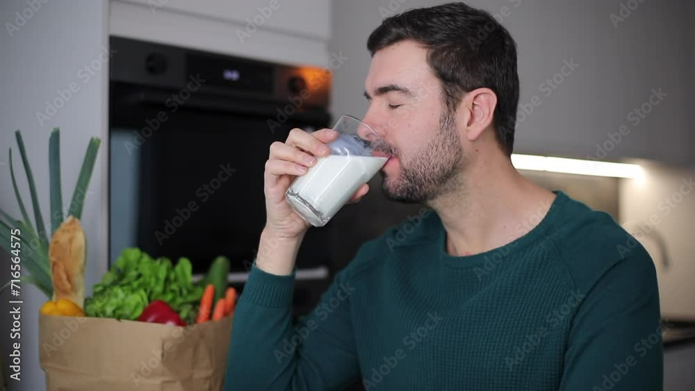 Handsome man drinking some milk 