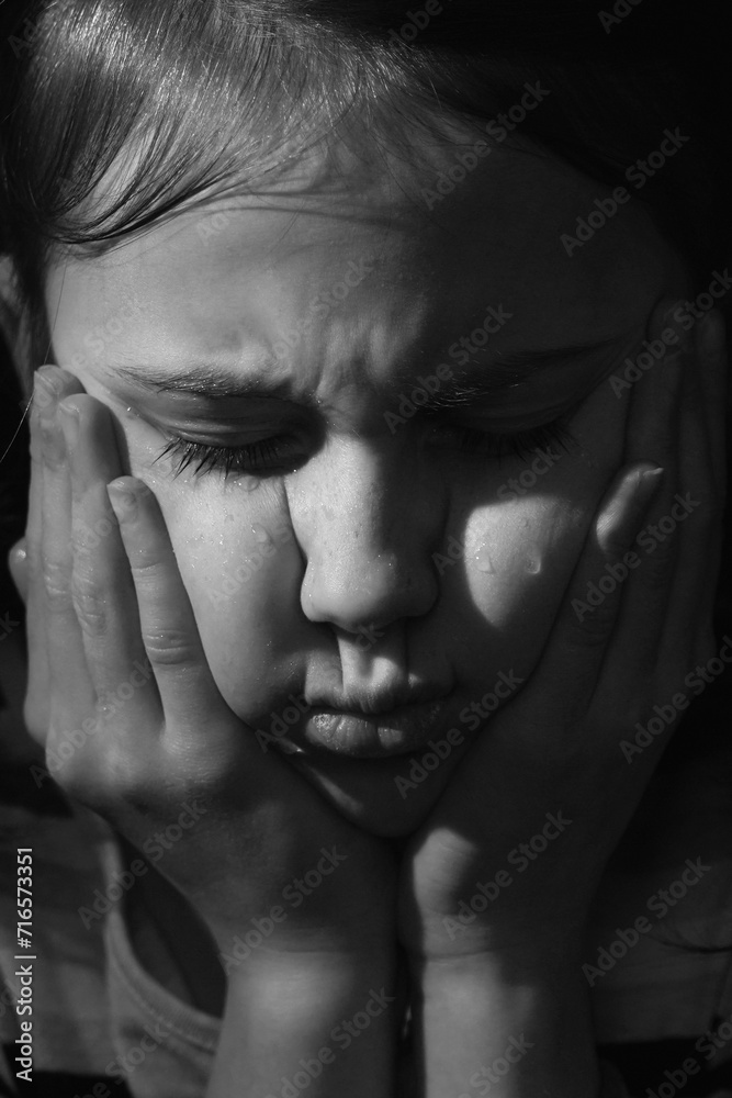 Black and white vertical portrait of crying cute little offended child girl. Black and white vertical portrait of crying cute little offended child girl.
